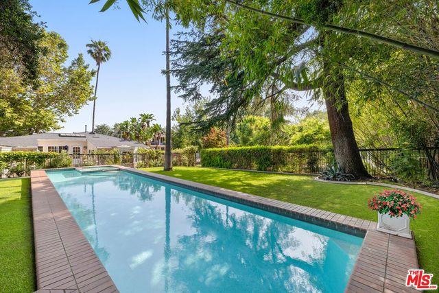 a view of swimming pool with a back yard