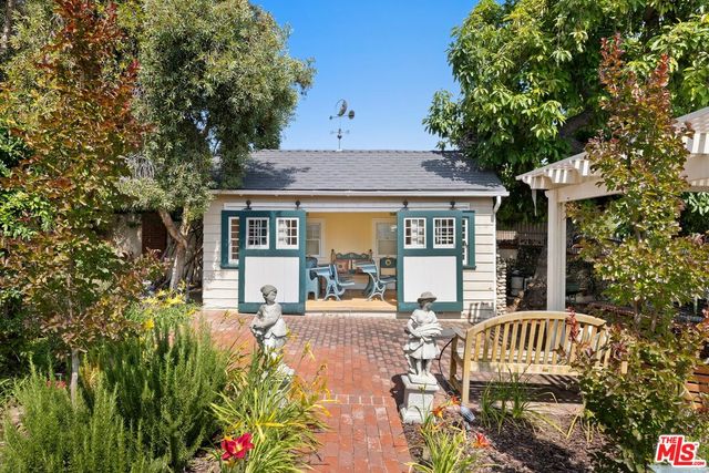 a front view of a house with garden and patio