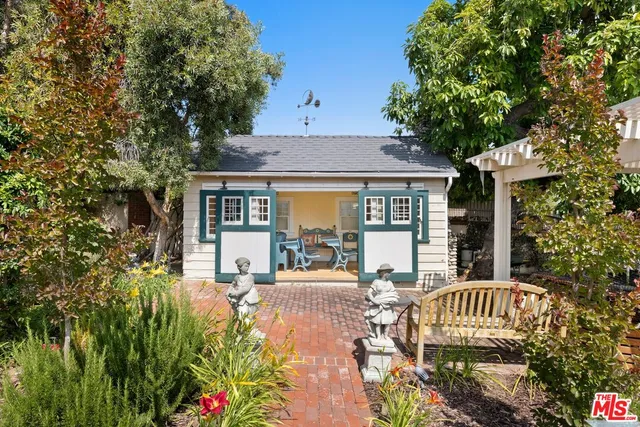 a front view of a house with garden and patio
