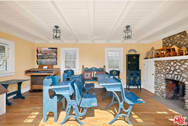 a living room with fireplace furniture and windows