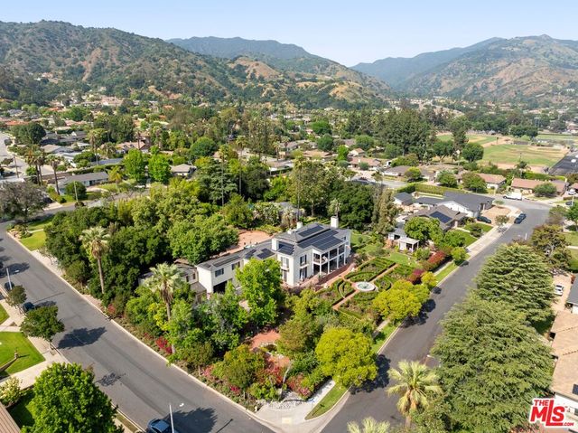 an aerial view of a houses with yard