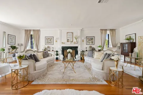 a living room with fireplace furniture and a wooden floor