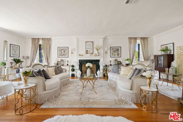 a living room with fireplace furniture and a wooden floor