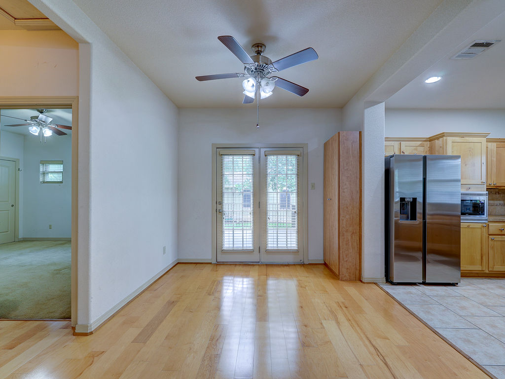 9707 Anderson Mill Road, Unit 22 Austin, TX 78750 - Photo 17 of 39 An open concept living area boasts elegant hardwood floors and convenient kitchen access.