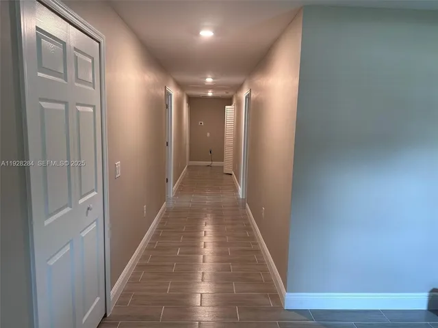 a view of hallway with wooden floor