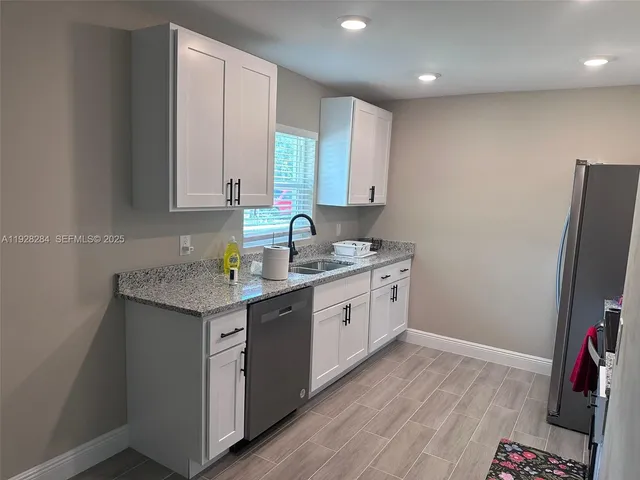 a kitchen with a sink stove and cabinets