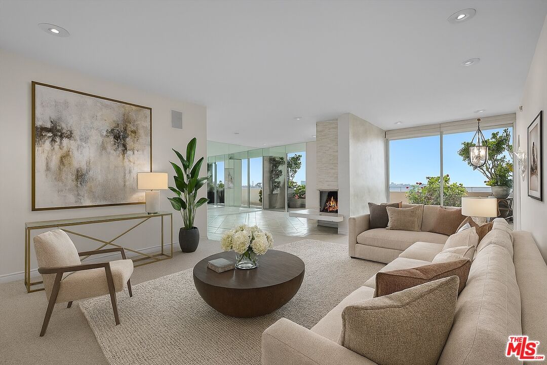 a living room with furniture and a potted plant