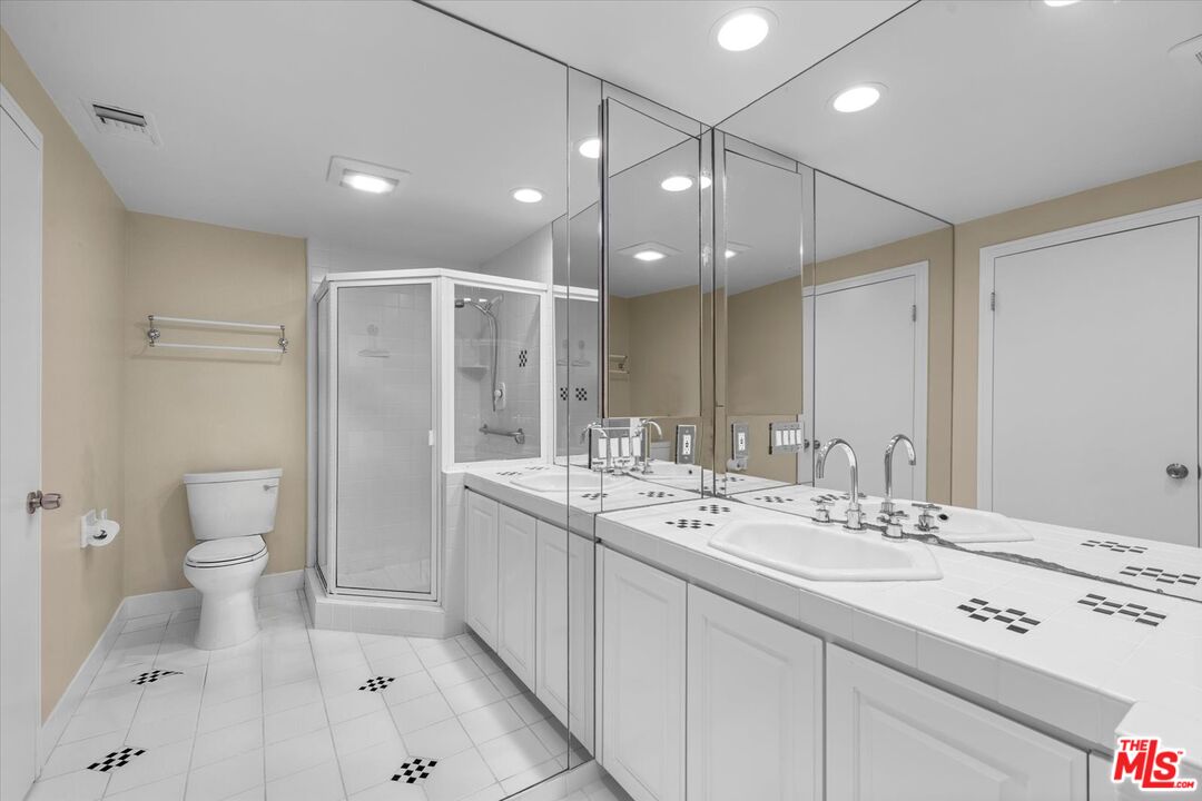 1333 South Beverly Glen Boulevard, Unit 904 Los Angeles, CA 90024 - Photo 13 of 32 a bathroom with a double vanity sink mirror and toilet