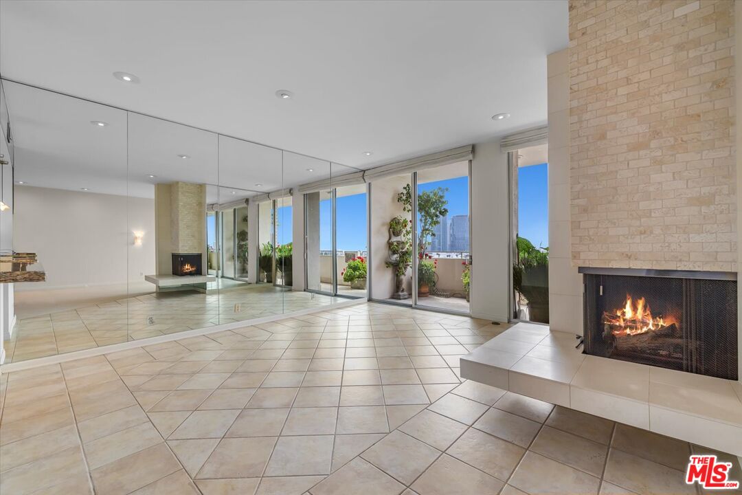1333 South Beverly Glen Boulevard, Unit 904 Los Angeles, CA 90024 - Photo 16 of 32 a view of an empty room with furniture and a fireplace