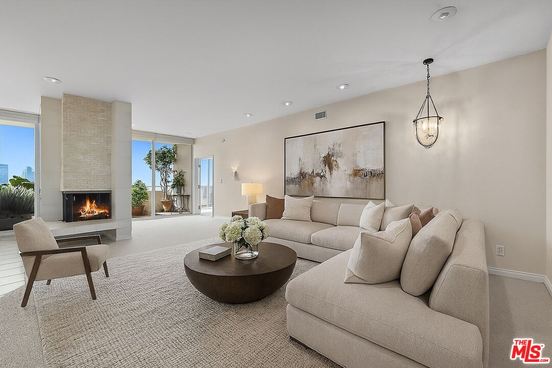 1333 South Beverly Glen Boulevard, Unit 904 Los Angeles, CA 90024 - Photo 7 of 32 a living room with furniture and a fireplace
