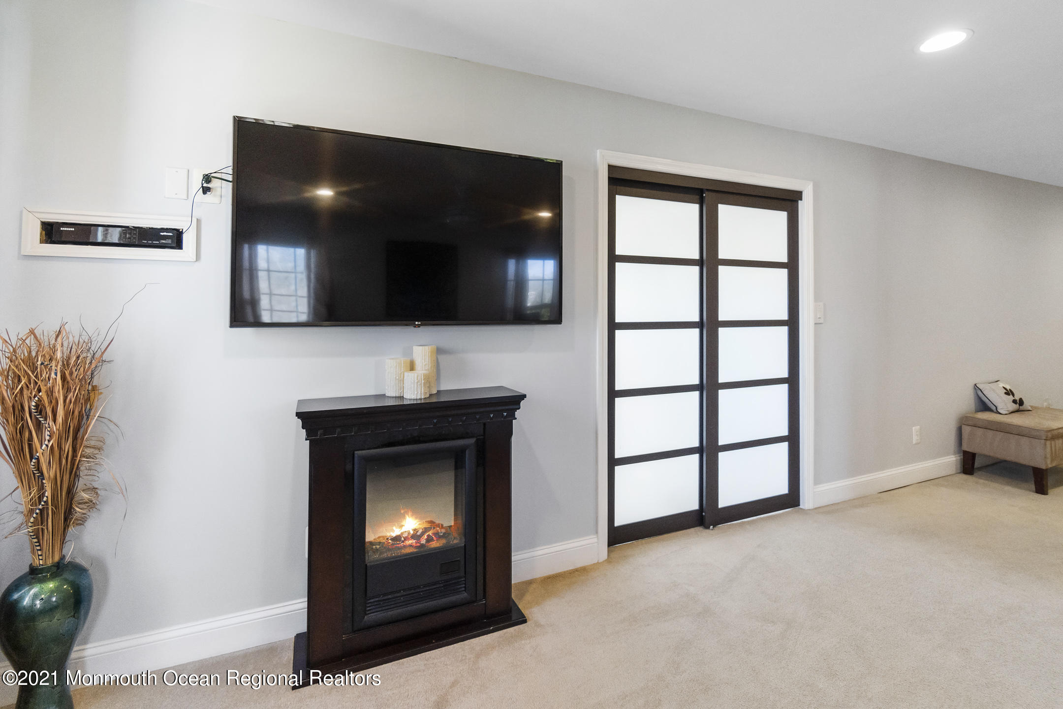 9 Rutgers Drive Howell, NJ 07731 - Photo 35 of 45 a living room with a flat screen tv and a fireplace