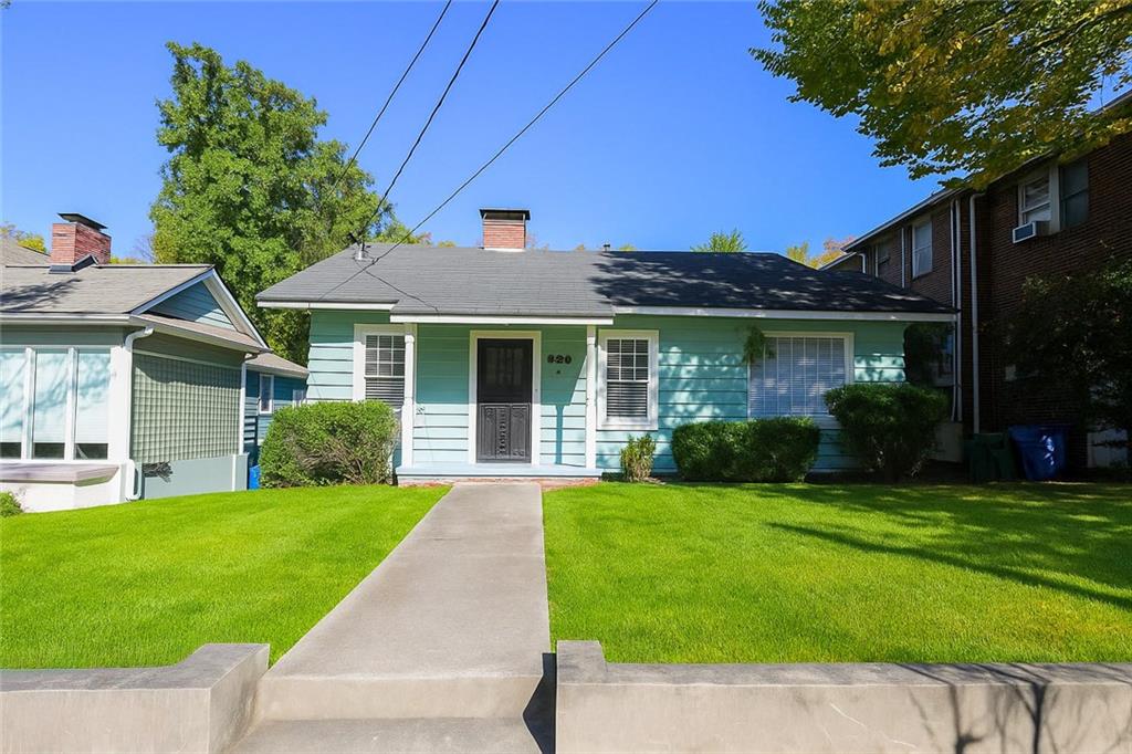 a front view of a house with a yard and porch