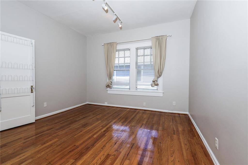 920 Greenwood Avenue Northeast, Unit C Atlanta, GA 30306 - Photo 11 of 15 an empty room with wooden floor and windows