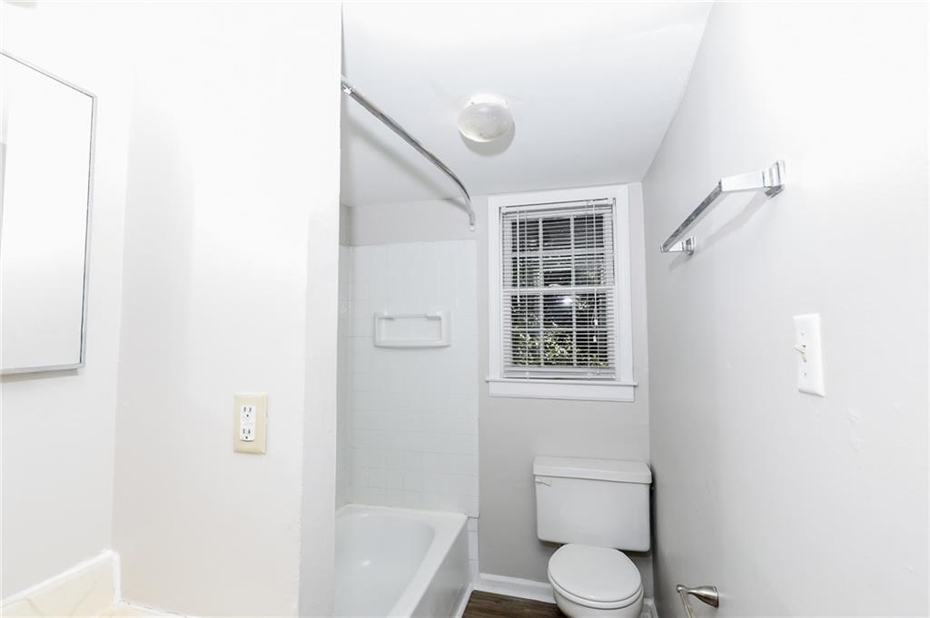920 Greenwood Avenue Northeast, Unit C Atlanta, GA 30306 - Photo 14 of 15 a white toilet sitting next to a bath tub