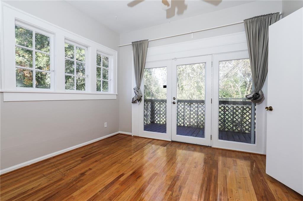 920 Greenwood Avenue Northeast, Unit C Atlanta, GA 30306 - Photo 3 of 15 an empty room with wooden floor and windows