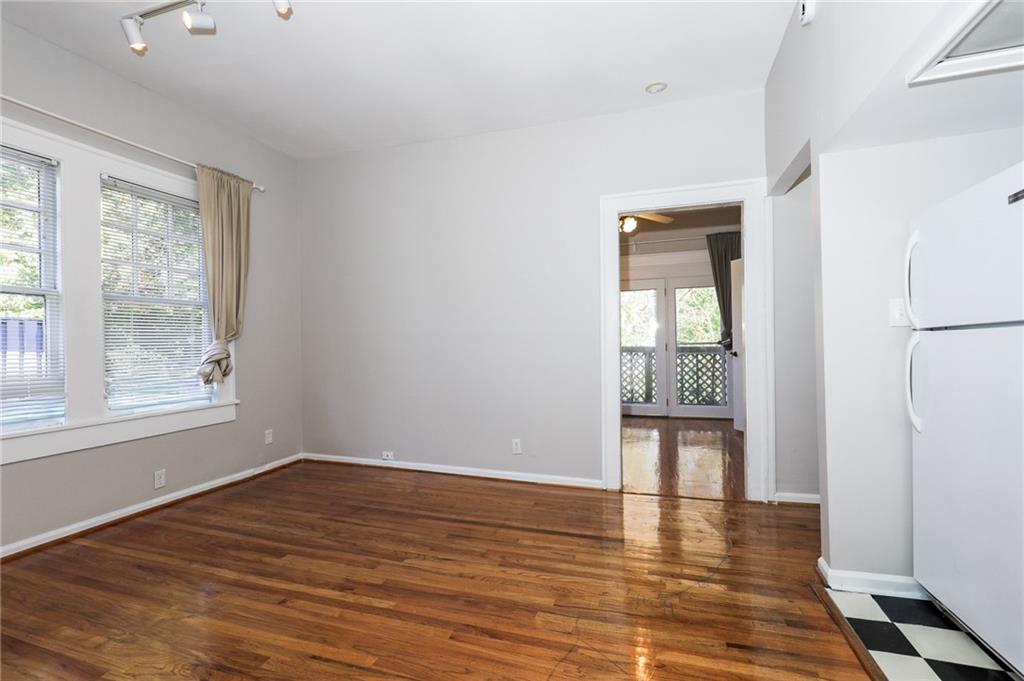 920 Greenwood Avenue Northeast, Unit C Atlanta, GA 30306 - Photo 5 of 15 a view of an empty room with a window and wooden floor