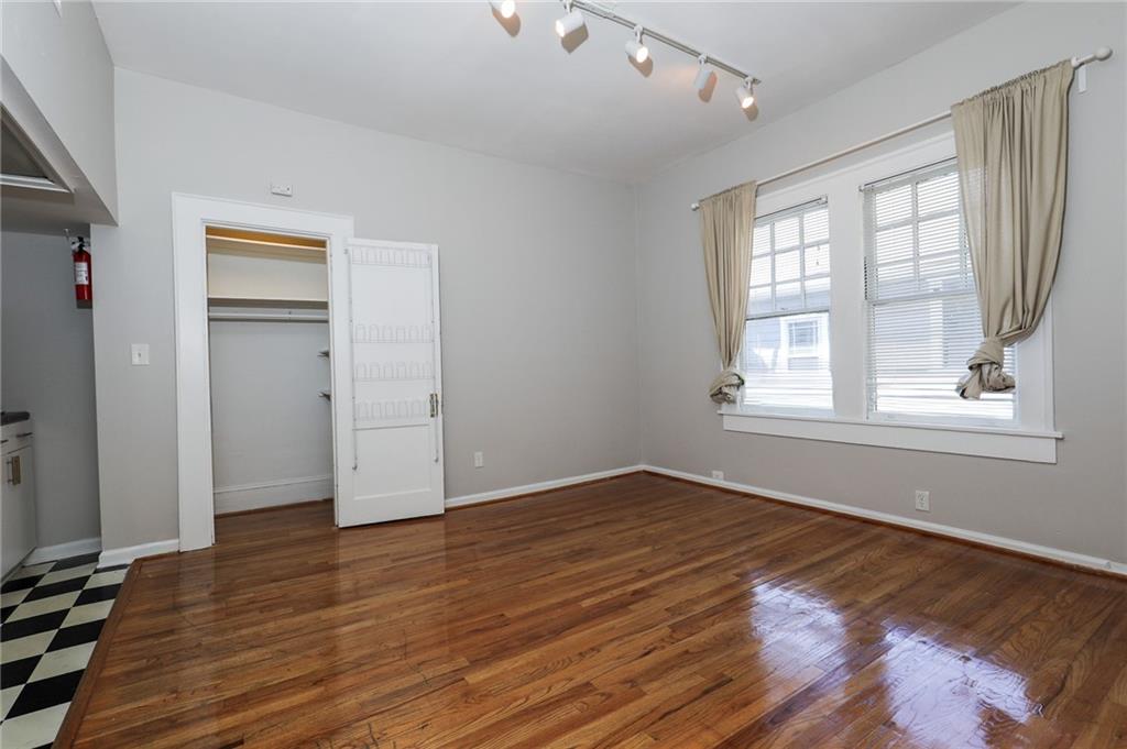 920 Greenwood Avenue Northeast, Unit C Atlanta, GA 30306 - Photo 6 of 15 an empty room with wooden floor and windows
