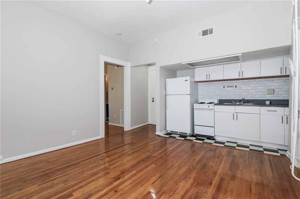 920 Greenwood Avenue Northeast, Unit C Atlanta, GA 30306 - Photo 7 of 15 a view of a kitchen with wooden floor and a sink
