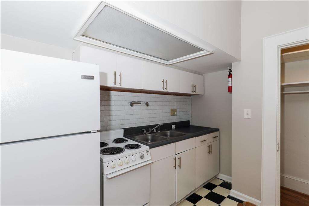 920 Greenwood Avenue Northeast, Unit C Atlanta, GA 30306 - Photo 9 of 15 a kitchen with appliances cabinets and a sink
