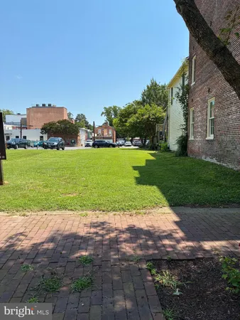 a view of a garden with a building in the background