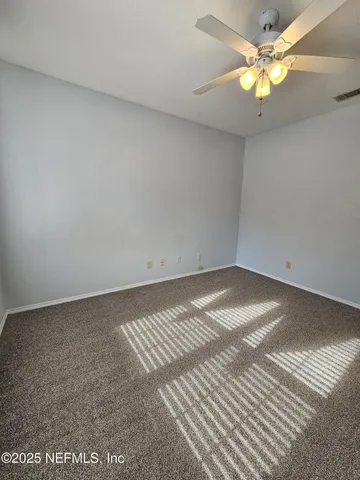 a view of a room with a fan and a fan