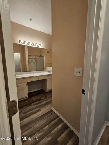 a view of entryway and hall with wooden floor