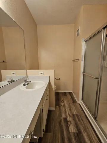 a bathroom with a sink a mirror and a shower