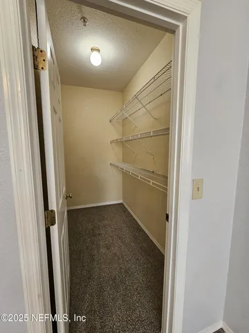 a bathroom with a granite countertop sink toilet a mirror and shower