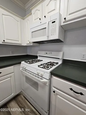 a stove top oven sitting inside of a kitchen