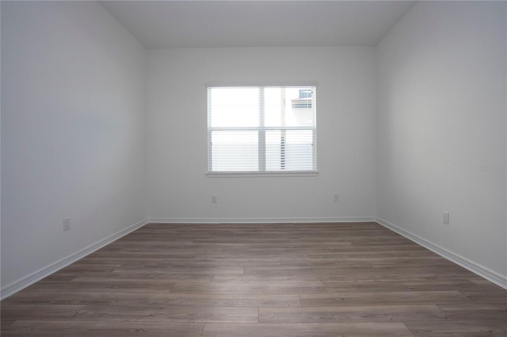 14184 Hammock Crest Way Riverview, FL 33569 - Photo 21 of 59 an empty room with wooden floor and windows
