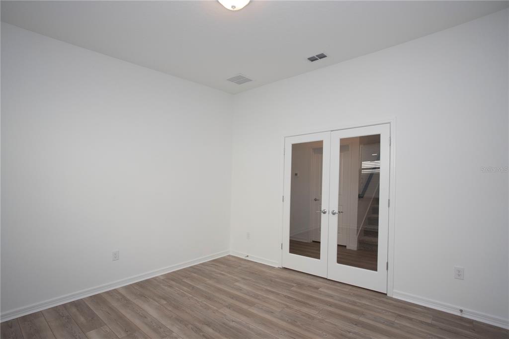 14184 Hammock Crest Way Riverview, FL 33569 - Photo 23 of 59 a view of an empty room with wooden floor