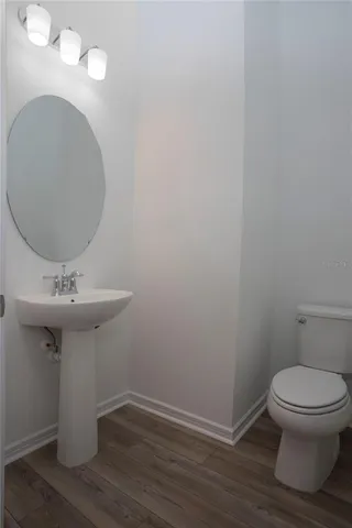 a kitchen with stainless steel appliances a sink cabinets and wooden floor