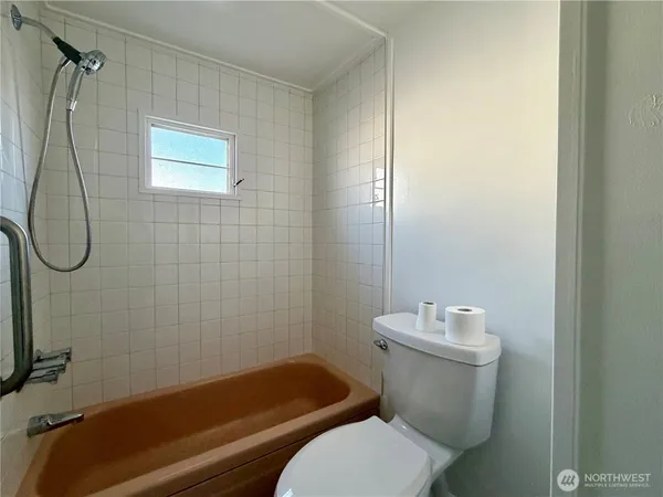 a bathroom with a toilet sink and shower