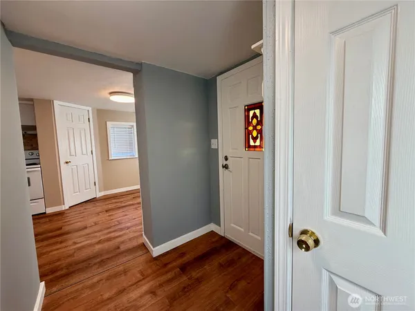 a view of a hallway with wooden floor
