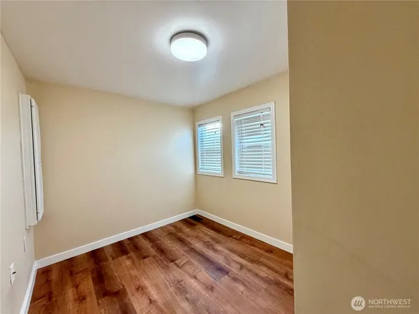 a view of a room with wooden floor and fan