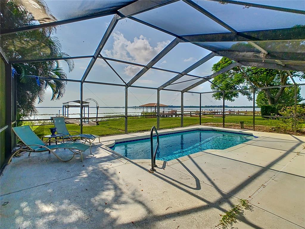 ENJOY YOUR LAKEFRONT POOL HOME with 3 BR / 2 BA and 100’ OF LAKEFRONTAGE on LAKE REEDY.  