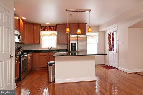 6304 Ford Road Frederick, MD 21702 - Photo 4 of 29 a kitchen with stainless steel appliances granite countertop a stove a sink and a refrigerator