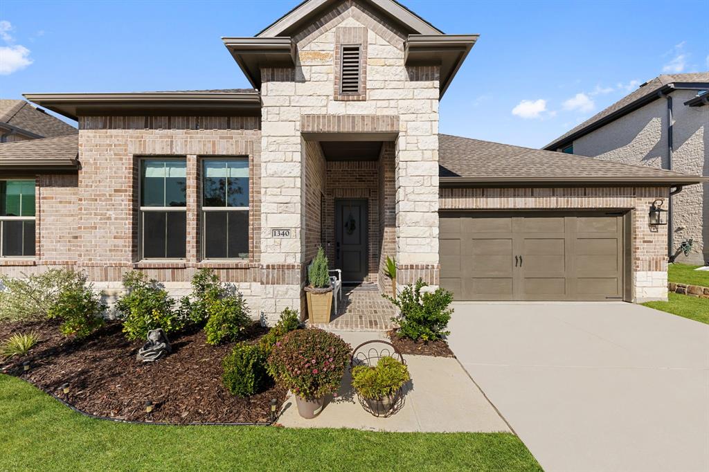 1340 Cartona Road Fate, TX 75087 - Photo 2 of 32 a front view of a house with garden