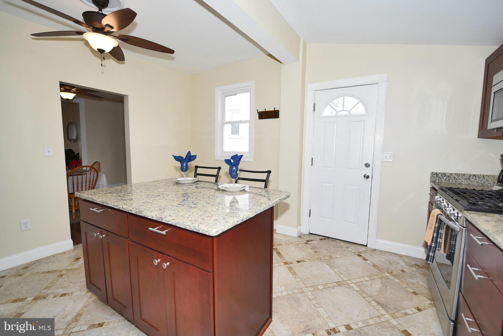 710 Elmwood Road Baltimore, MD 21206 - Photo 11 of 30 a kitchen with stainless steel appliances granite countertop a sink and a refrigerator