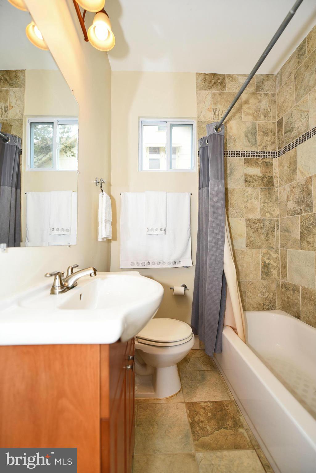 710 Elmwood Road Baltimore, MD 21206 - Photo 12 of 30 a bathroom with a sink toilet and shower