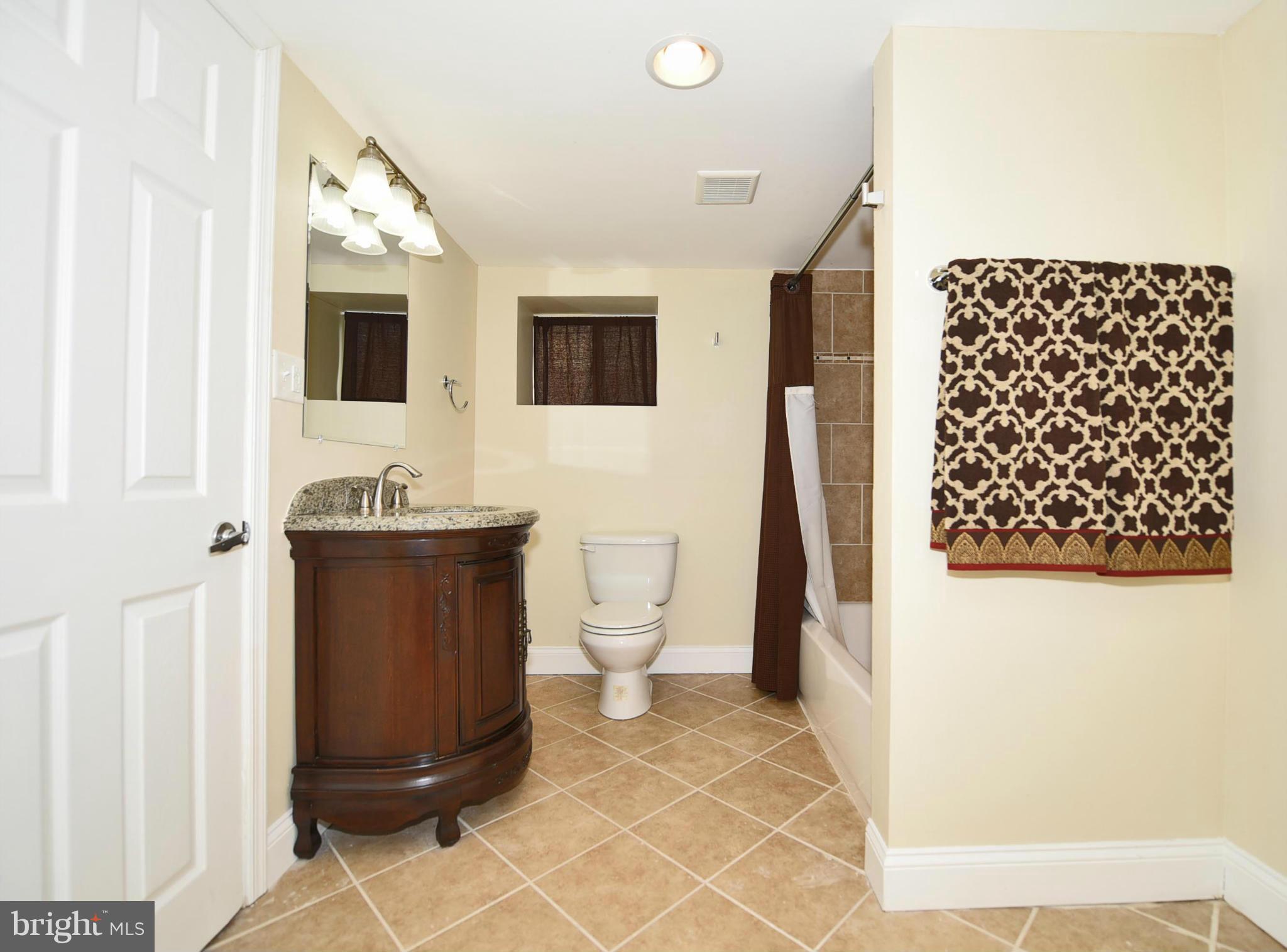 710 Elmwood Road Baltimore, MD 21206 - Photo 22 of 30 a bathroom with a sink a toilet and mirror