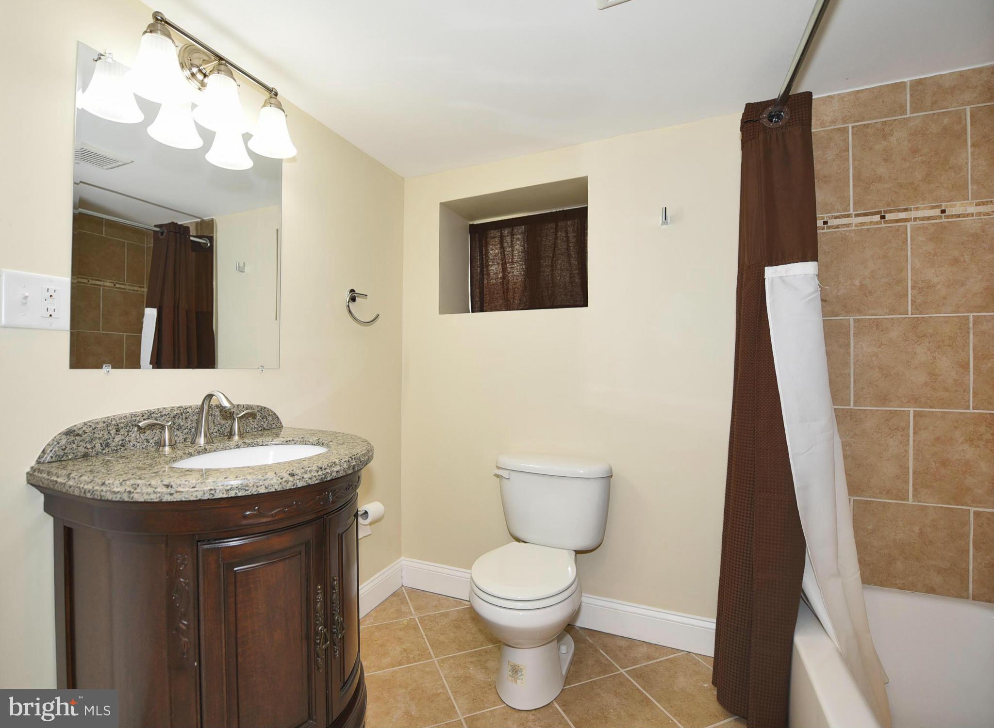 710 Elmwood Road Baltimore, MD 21206 - Photo 23 of 30 a bathroom with a toilet sink and mirror