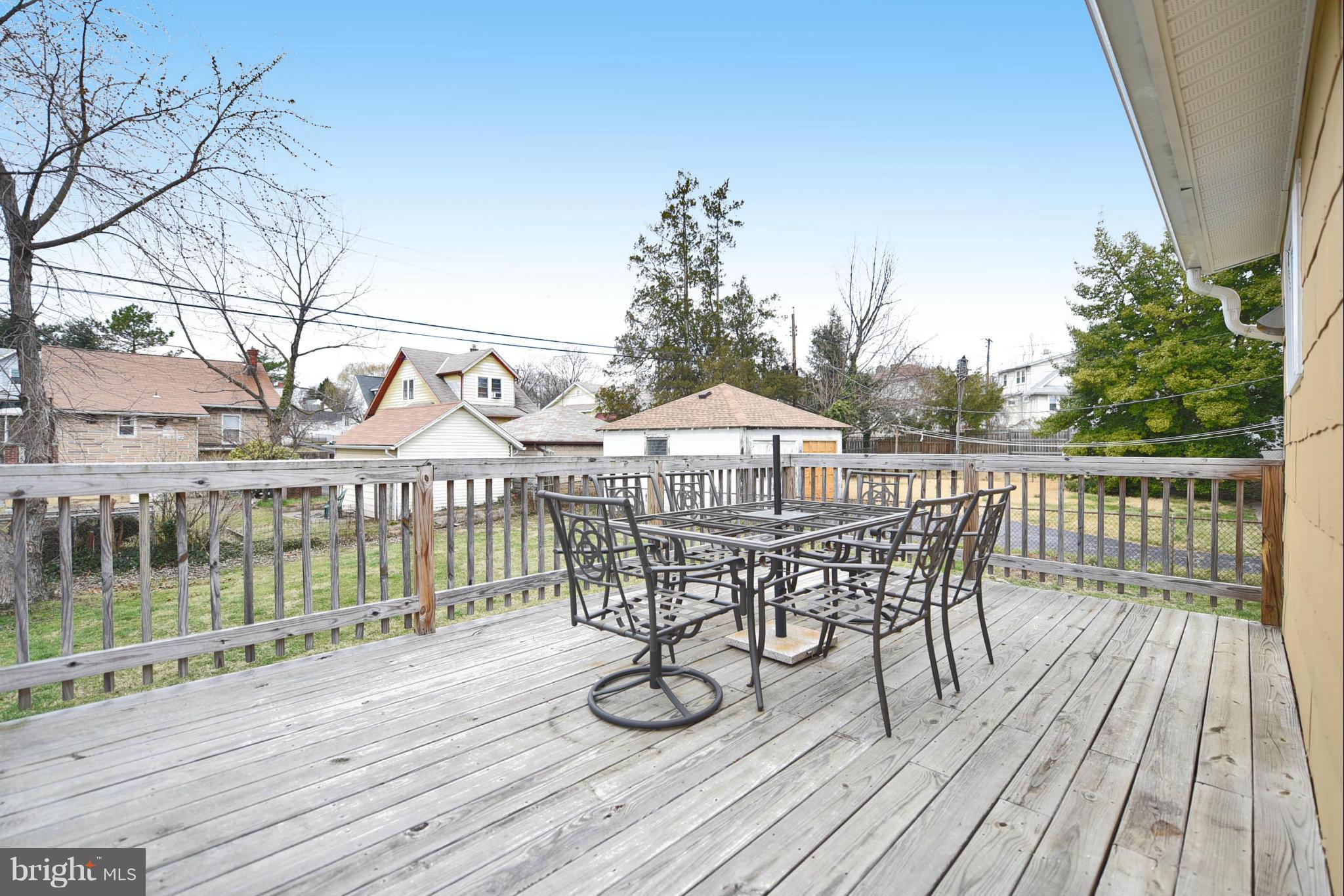 710 Elmwood Road Baltimore, MD 21206 - Photo 24 of 30 a view of a house with wooden deck and furniture