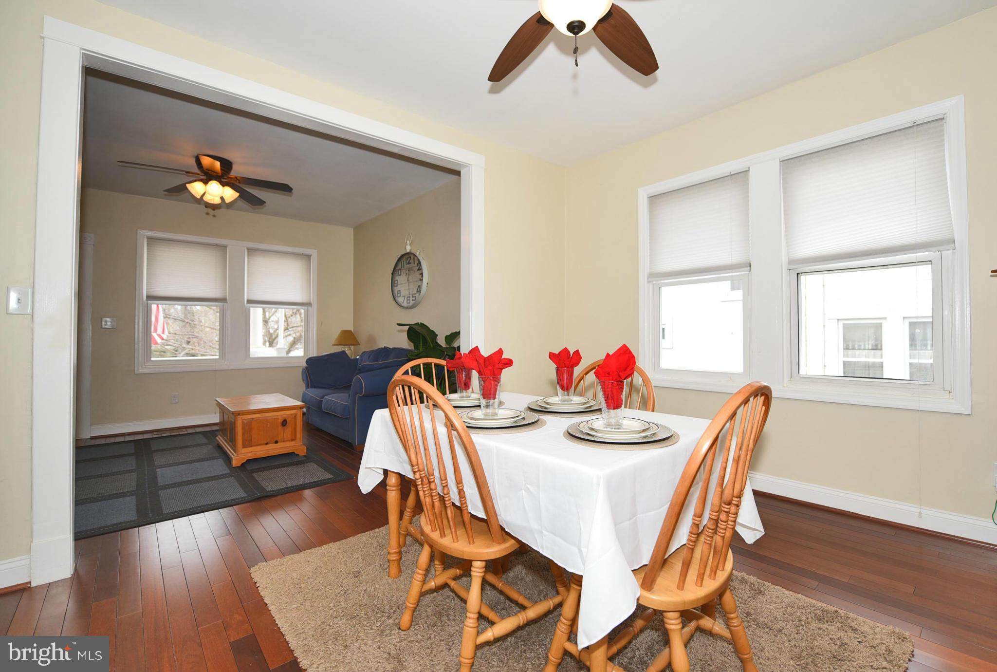 710 Elmwood Road Baltimore, MD 21206 - Photo 5 of 30 a dining room with furniture a window and wooden floor