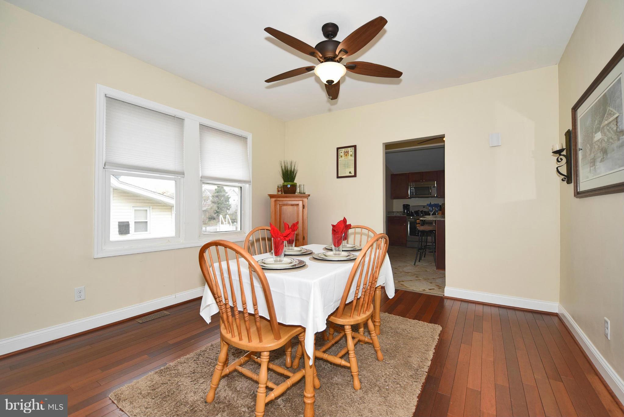 710 Elmwood Road Baltimore, MD 21206 - Photo 6 of 30 a dining room with furniture a window and wooden floor