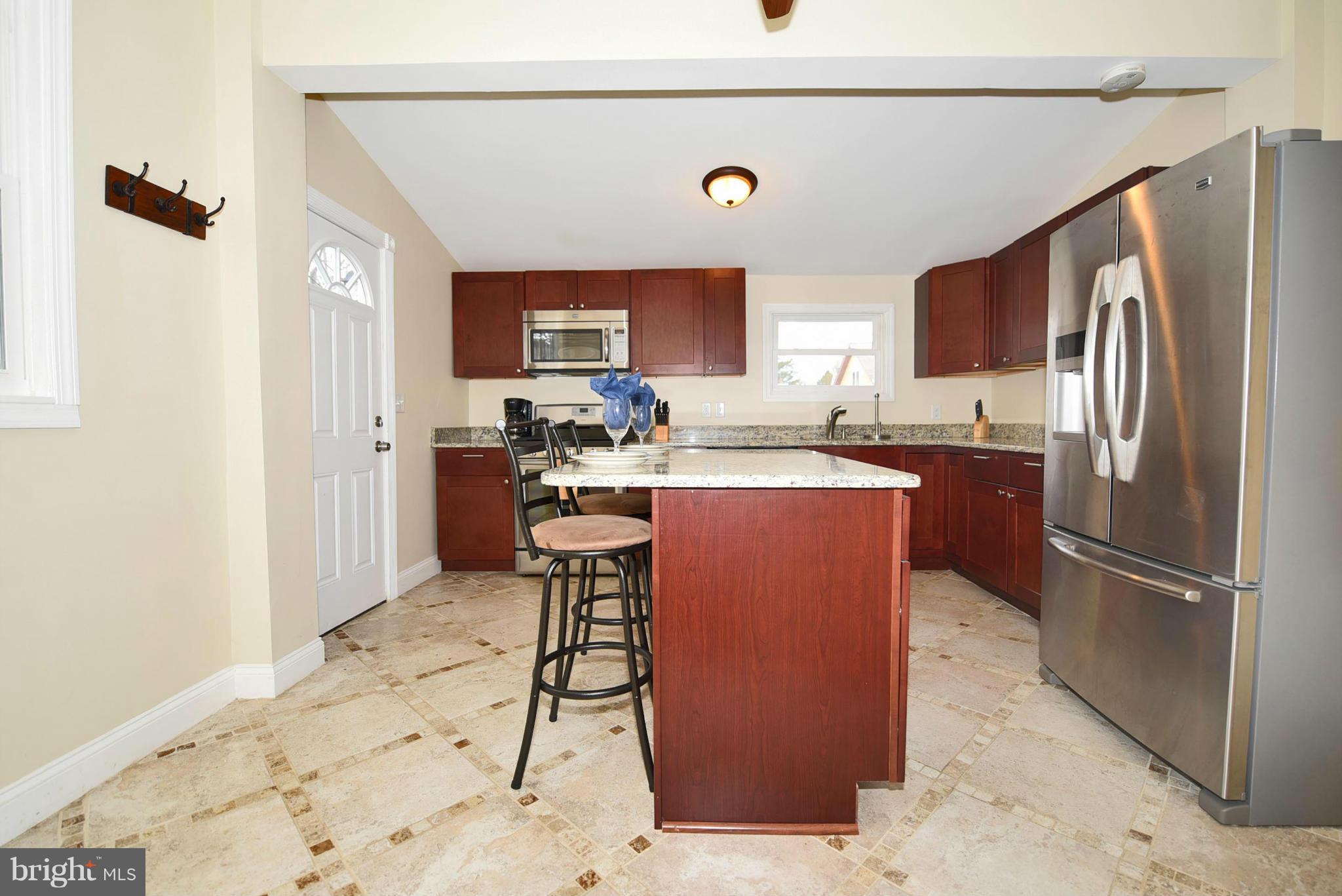 710 Elmwood Road Baltimore, MD 21206 - Photo 9 of 30 a kitchen with stainless steel appliances granite countertop a refrigerator sink and cabinets