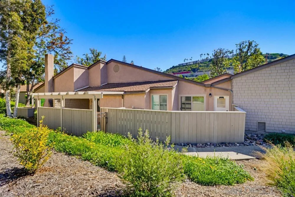 5571 Adobe Falls Road, Unit D San Diego, CA 92120 - Photo 12 of 60 a front view of a house with a garden