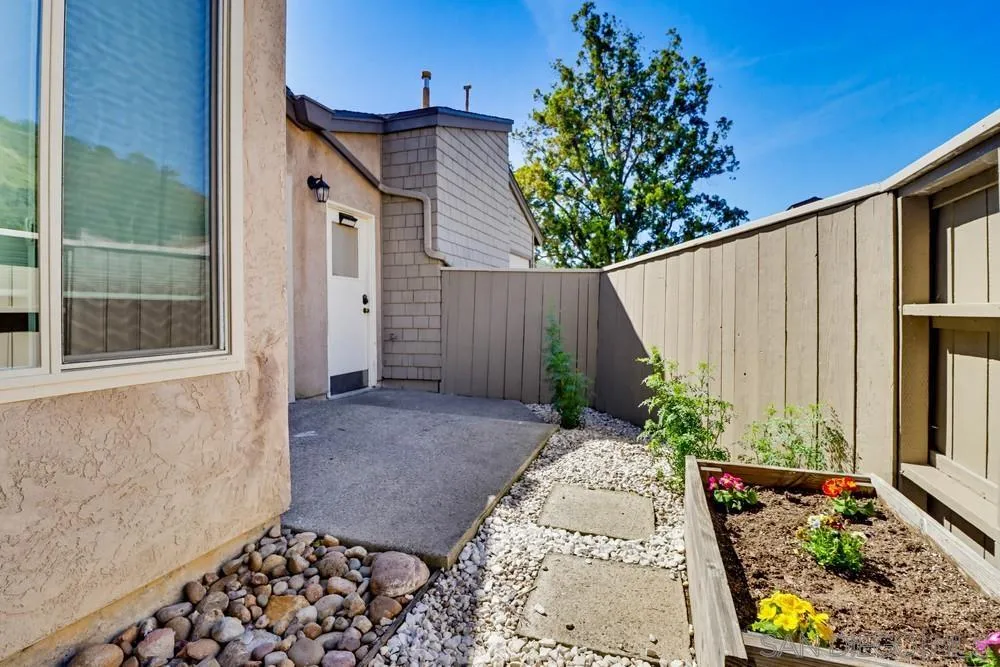 5571 Adobe Falls Road, Unit D San Diego, CA 92120 - Photo 15 of 60 a backyard of a house with lots of green space