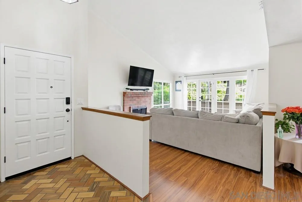 5571 Adobe Falls Road, Unit D San Diego, CA 92120 - Photo 16 of 60 a living room with furniture and a flat screen tv