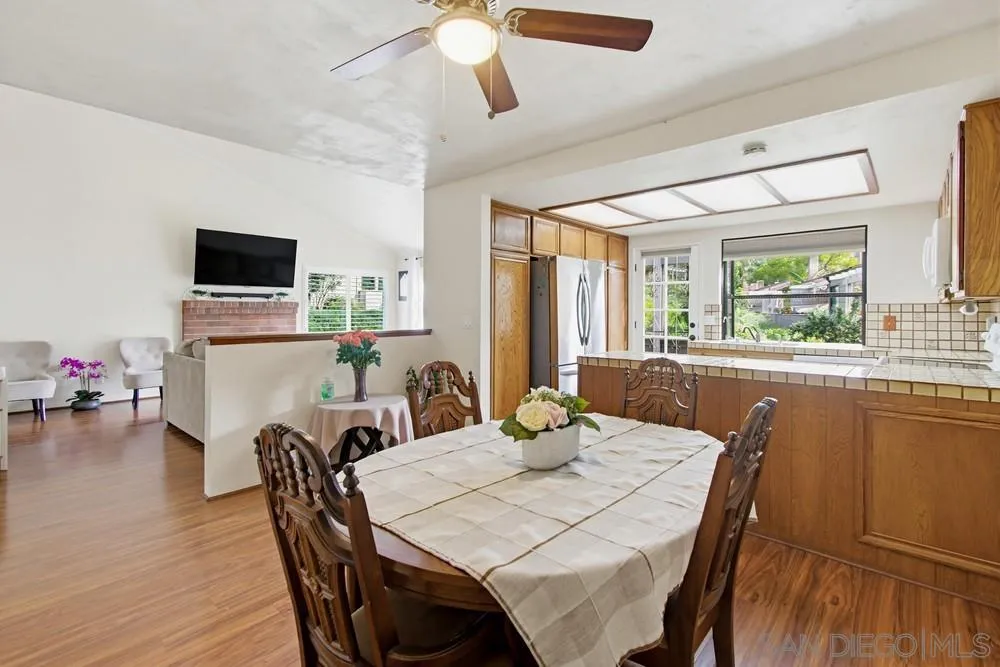 5571 Adobe Falls Road, Unit D San Diego, CA 92120 - Photo 22 of 60 a view of a dining room with furniture and a window
